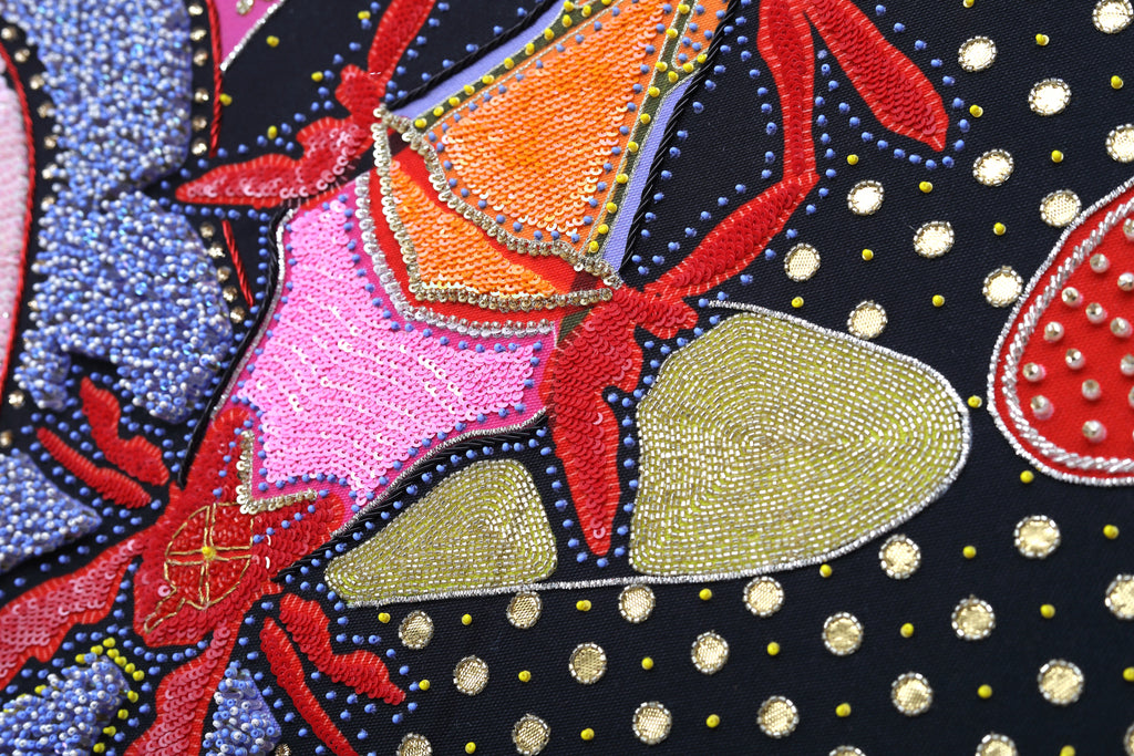 Sacred Offering (Black) detail: dense beadwork and crystal setting at close range
