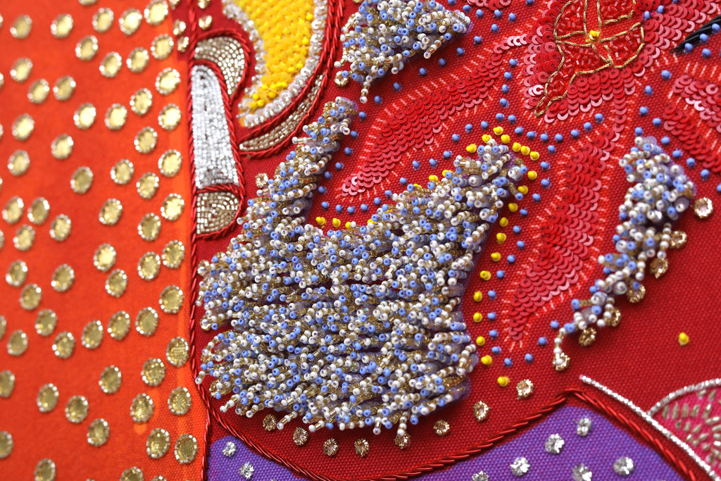 Sacred Offering (Maroon) detail: beaded trunk and crown on the maroon field